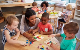 Preschool children and teacher interacting in a Head Start classroom