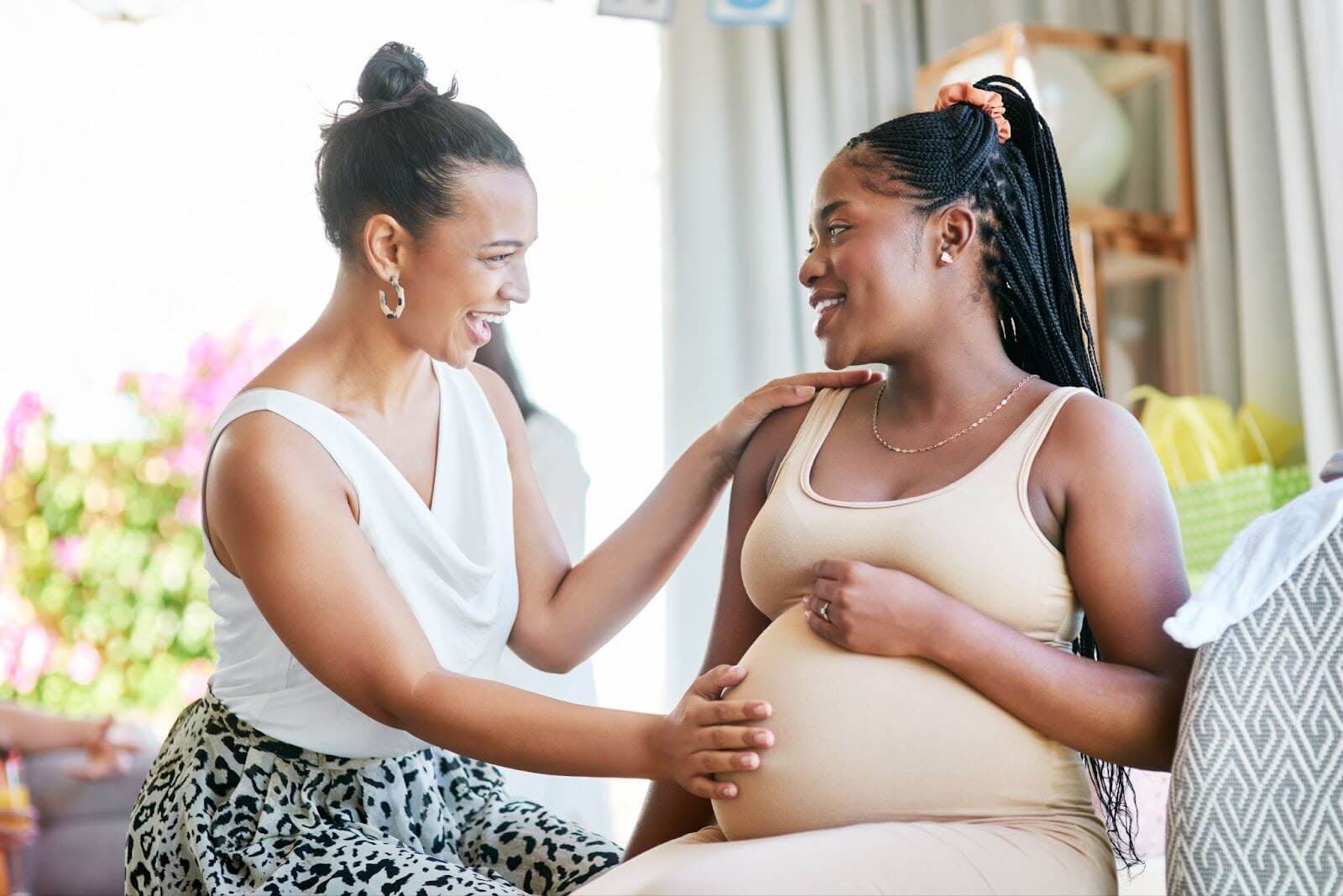 Pregnant mother smiling while receiving a home visit